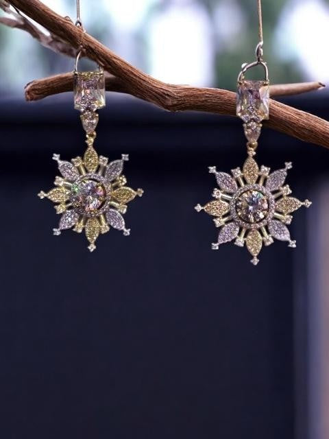 IXXIA Jewelry radiant starburst drop earrings with gold and silver tones, clear gemstones, and rectangular stud top. 