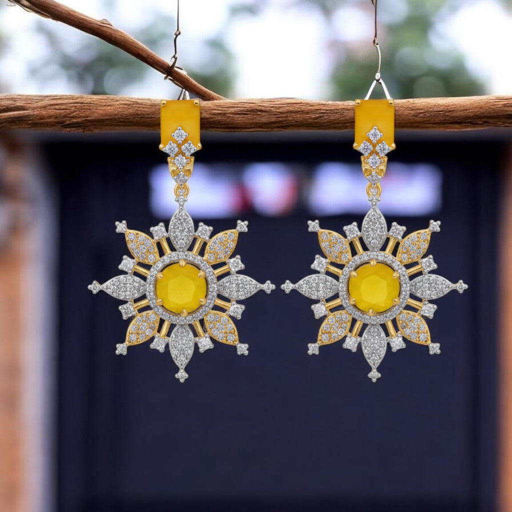 IXXIA Jewelry radiant starburst drop earrings with yellow gemstone, clear stones, gold and silver-toned metals.